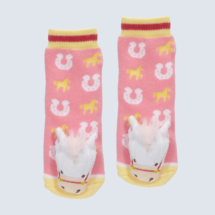 Two socks against a white background. The socks feature horse motifs, yellow and red cuffs, and a cute plush pink horse charm on the toe.