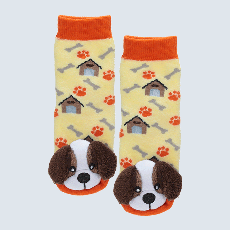 Two yellow and orange socks against a white backdrop. The socks feature a paw print and dog house pattern. Each sock has a cute plush St Bernard charm on the toe.
