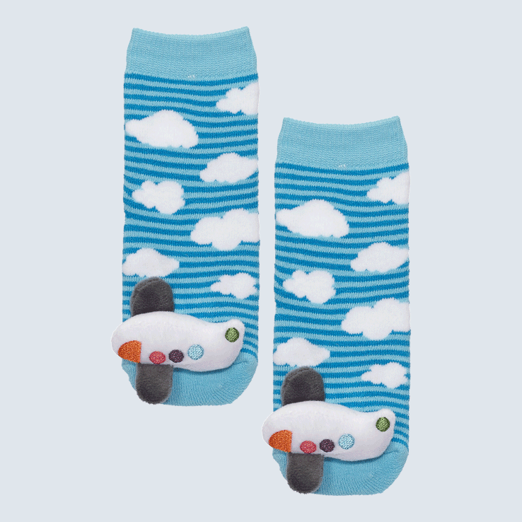To blue striped socks on a white backdrop. Each sock has fluffy white clouds on it and an airplane plush charm on the toe.