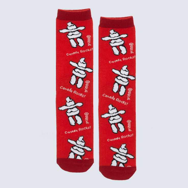 Two red socks against a white backdrop. The socks feature the words Canada Rocks and a pattern featuring a inukshuk design.