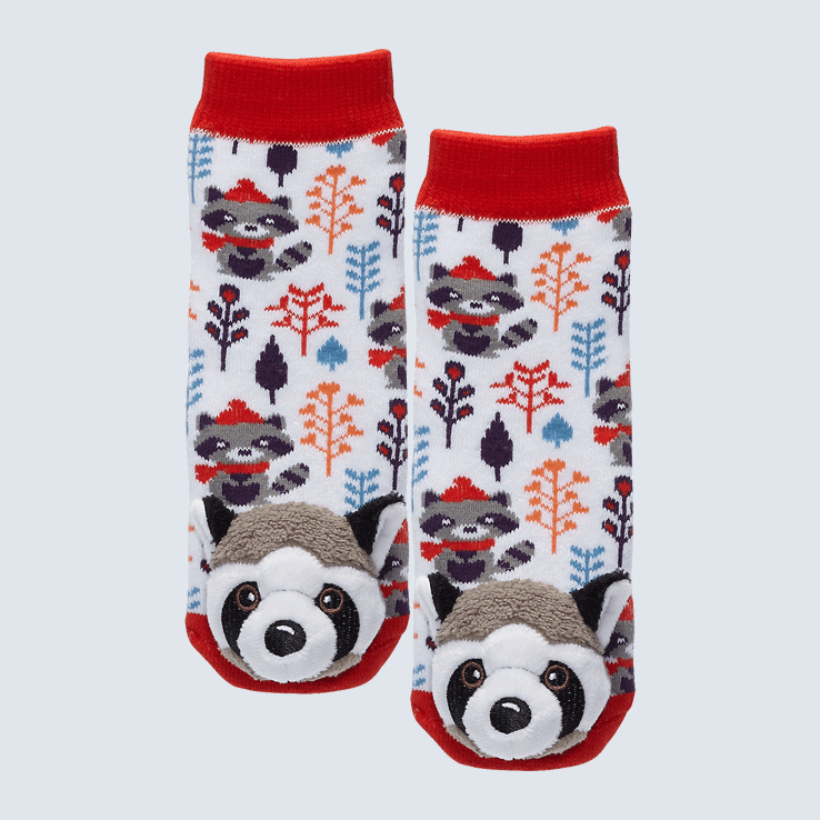 Two white, red, orange, and blue socks against a white background. The socks feature a Swedish style plant motif map and a raccoon plush charm on each toe.