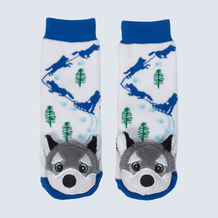 Two socks against a white background. The socks feature a winter scene and a cute plush husky charm on each toe.